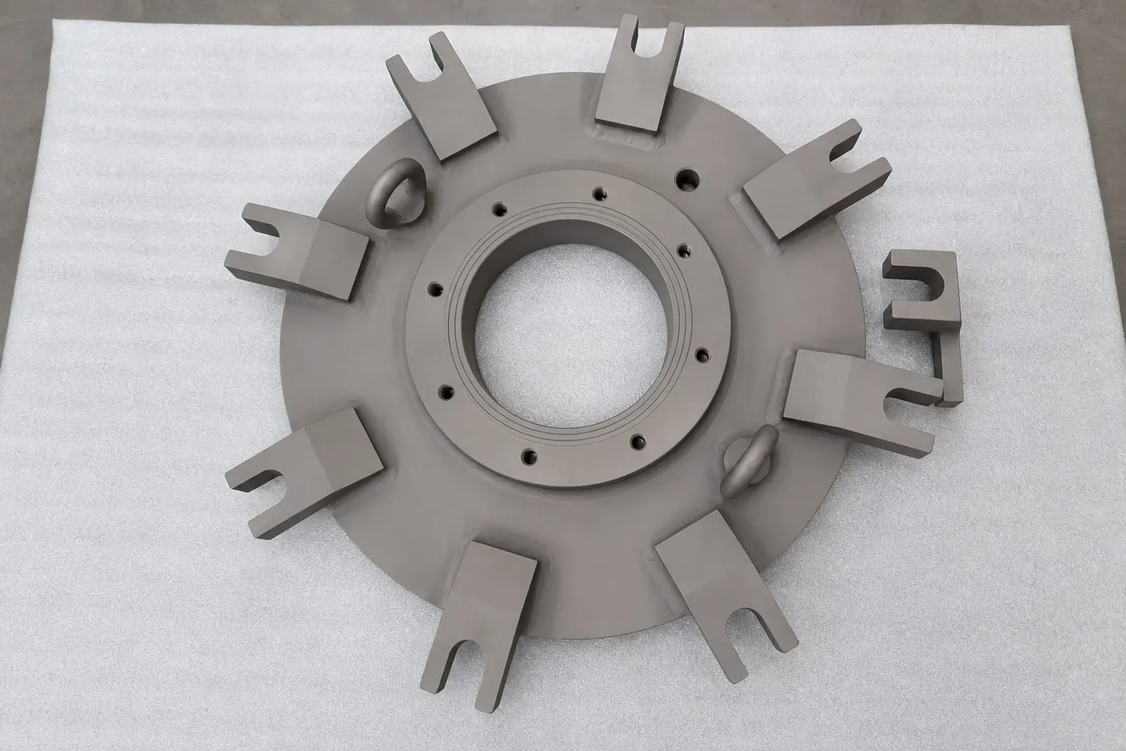 A real machined titanium component represents the titanium side of a hybrid material architecture; it is not the research specimen.
