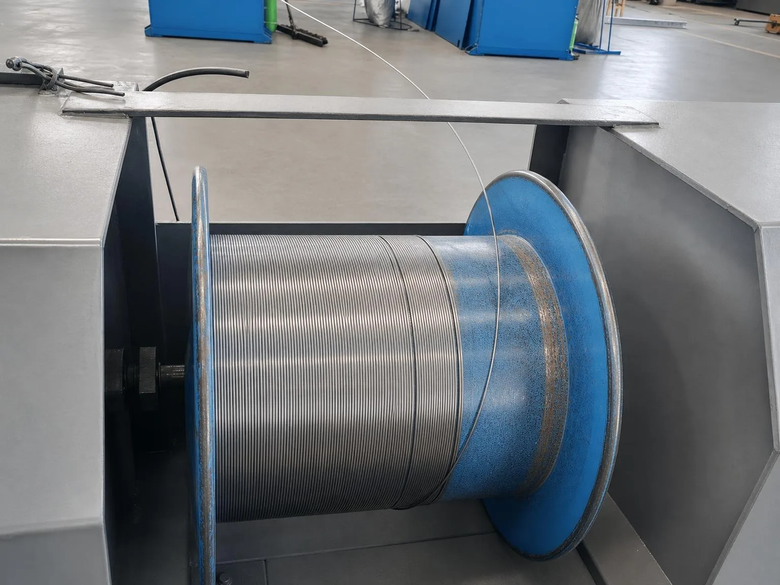Titanium wire on an industrial reel with a visible feed strand