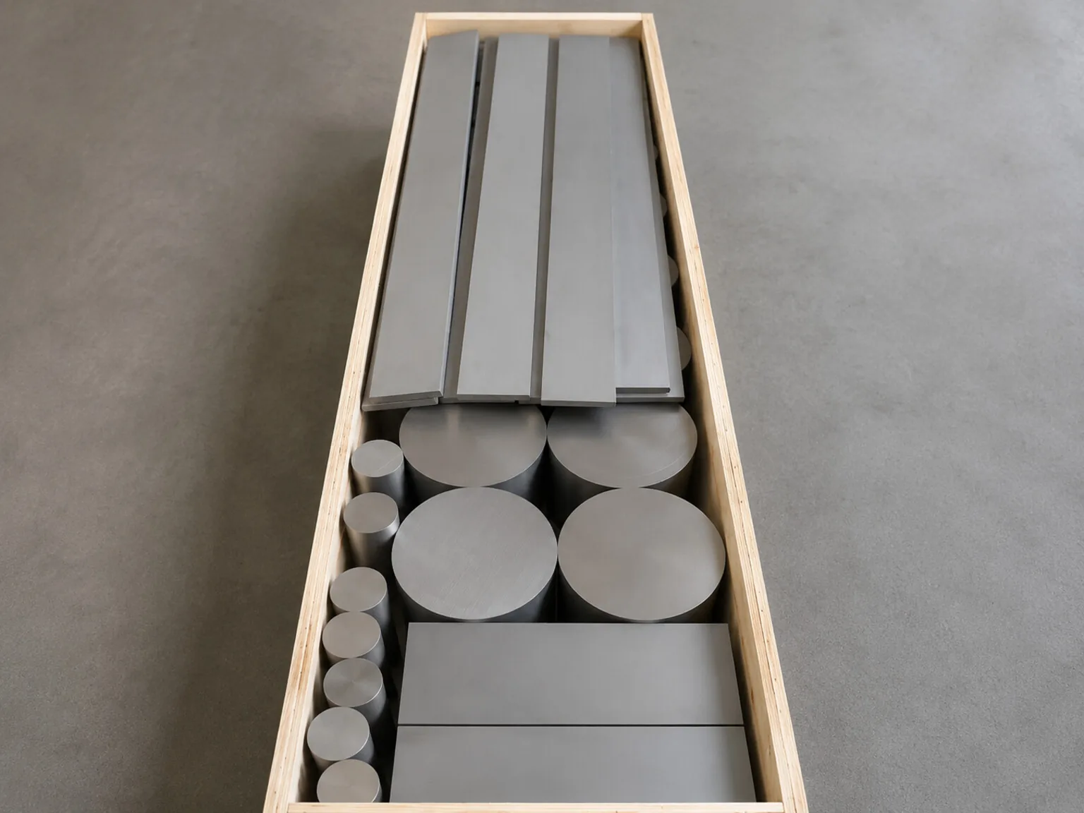 Representative titanium plate, bar and billet forms show the material boundary that procurement teams must reconnect to a qualified component route; they are not Safran program hardware