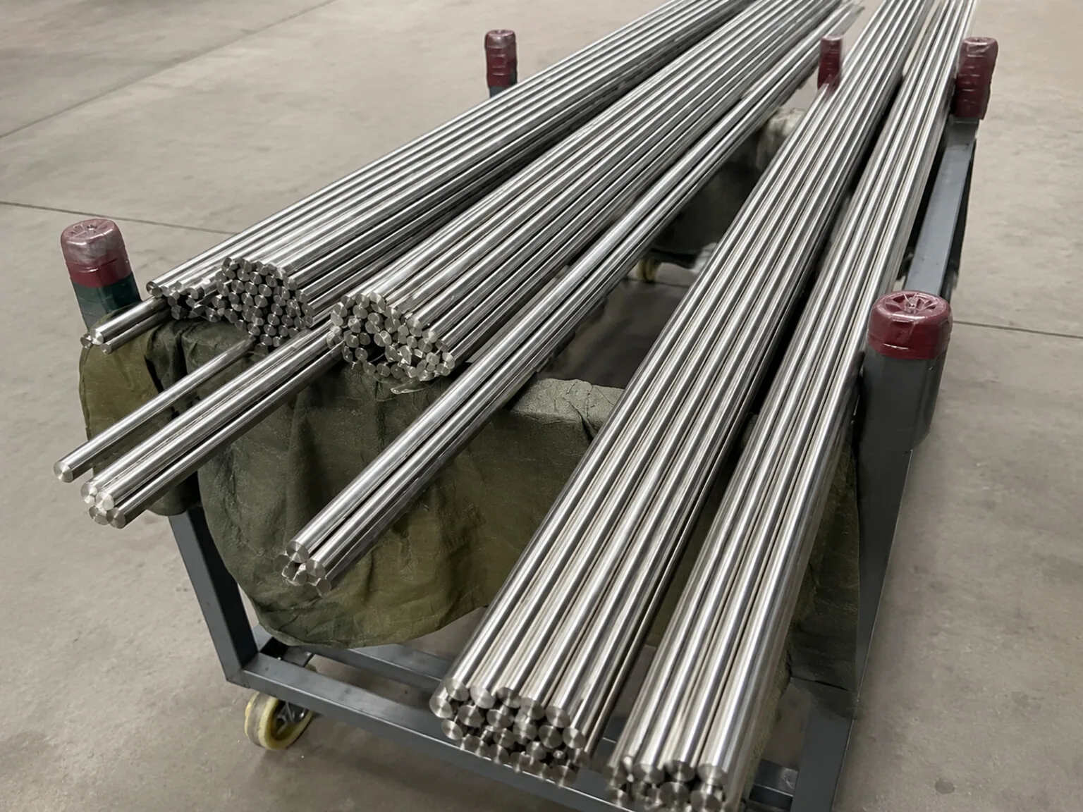 Representative titanium bar lots show why material identity must survive from incoming stock into a patient-specific device record; they are not implant components.