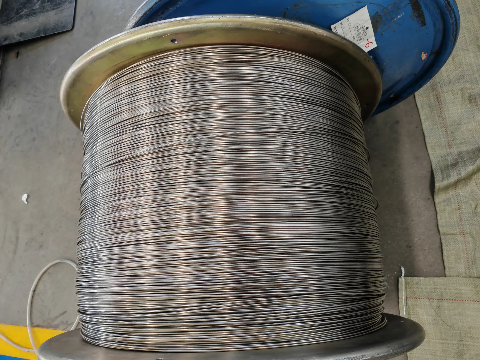 User-supplied titanium wire stock illustrates a potential product form that would require its own qualification; it is not a specimen from the reported study.