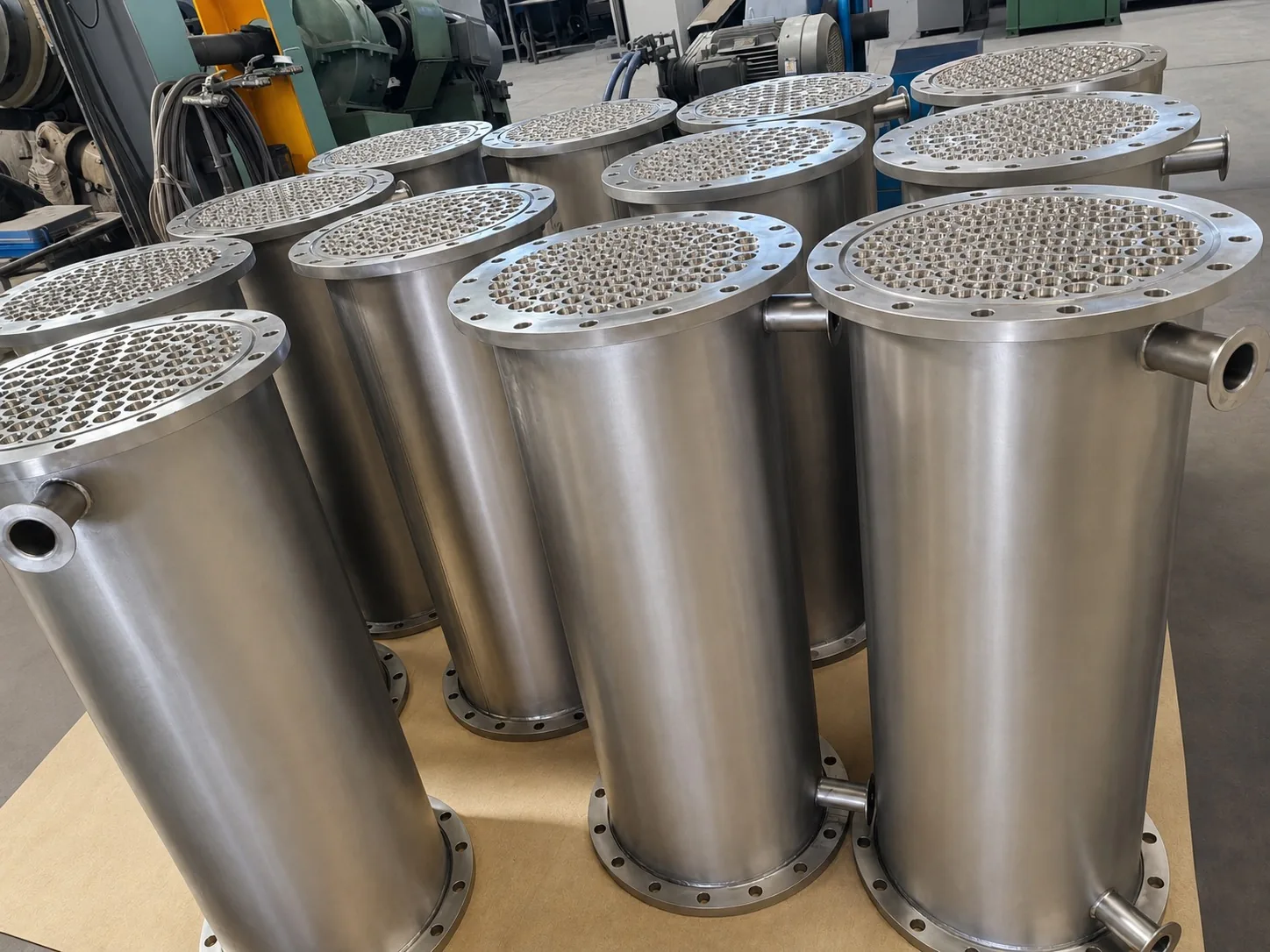 User-supplied titanium shell-and-tube equipment shows the fabricated surfaces and joints that make passive-film recovery relevant; it is not equipment from the study.