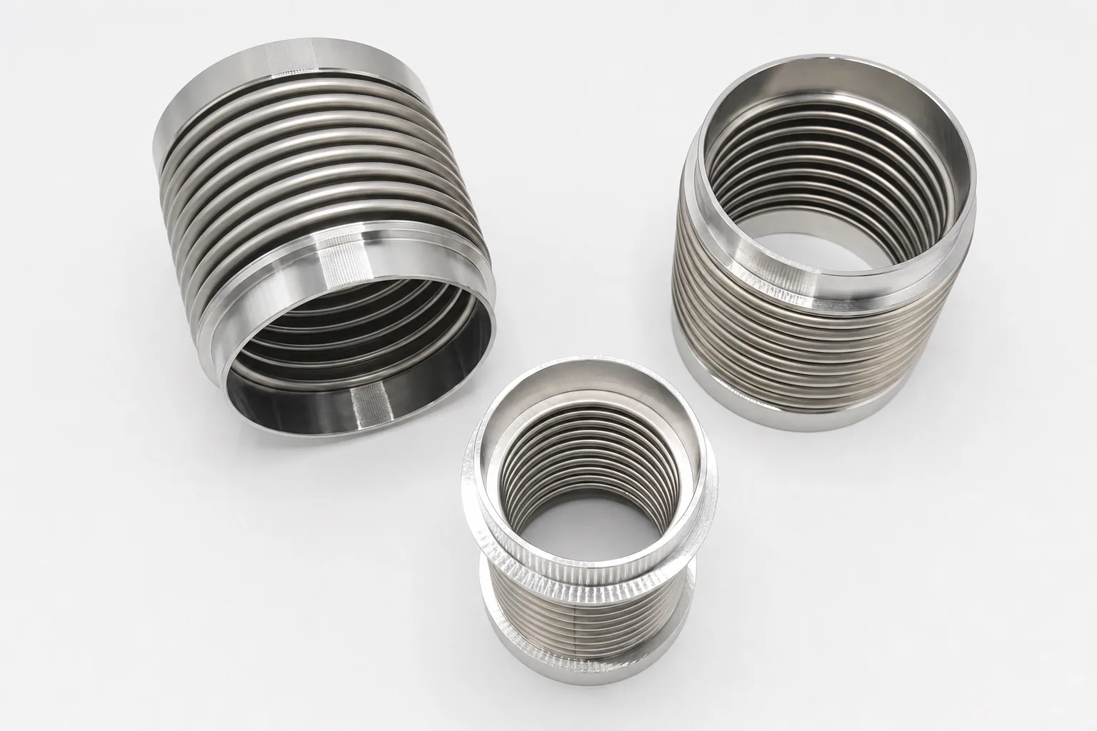User-supplied titanium bellows products show thin-wall geometry and finished surfaces; they are not TiAl parts or repaired study specimens.