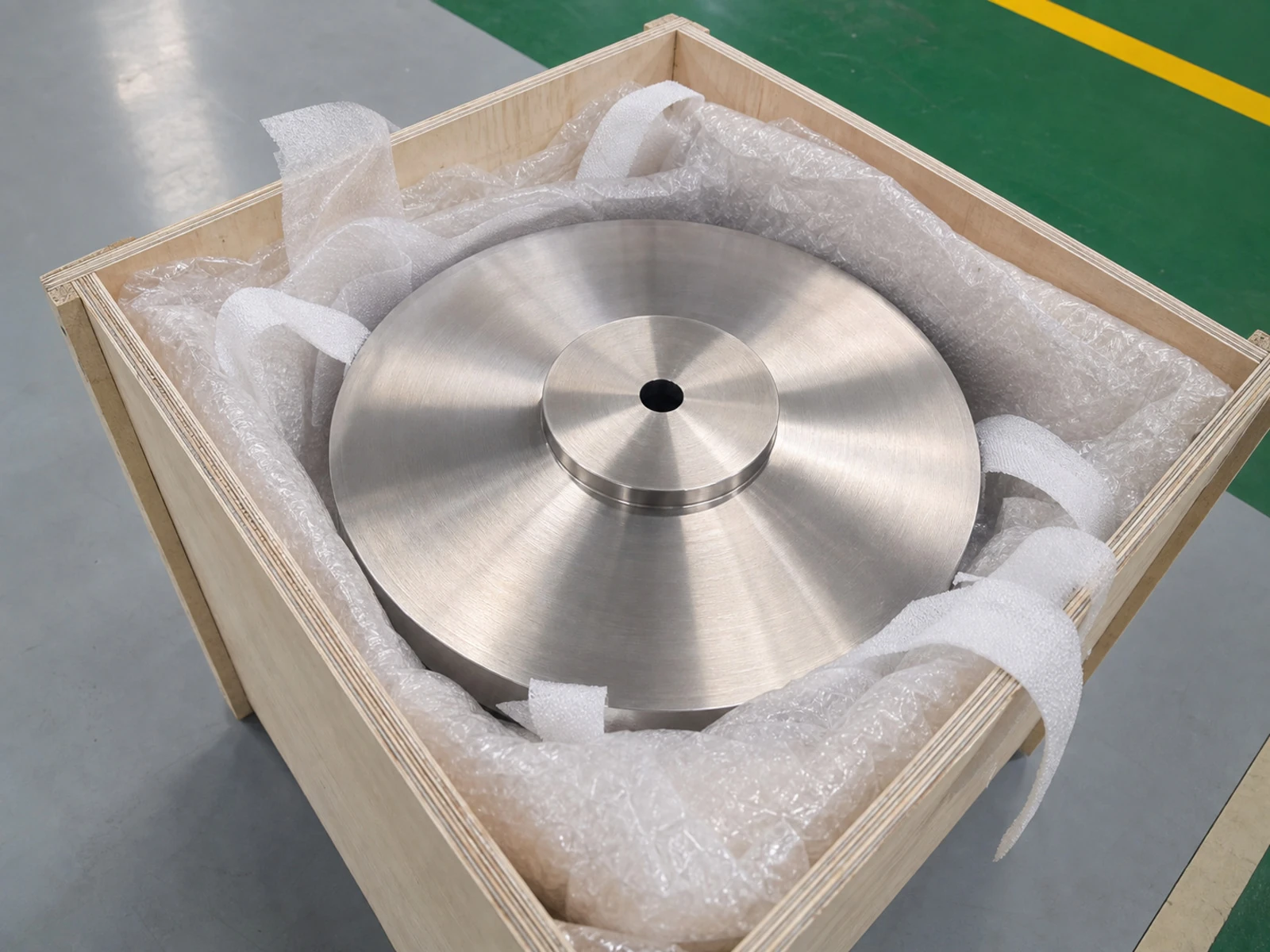 A packaged machined titanium disc in a wooden crate connects coating and substrate questions to shipment protection, handling condition and release documentation.