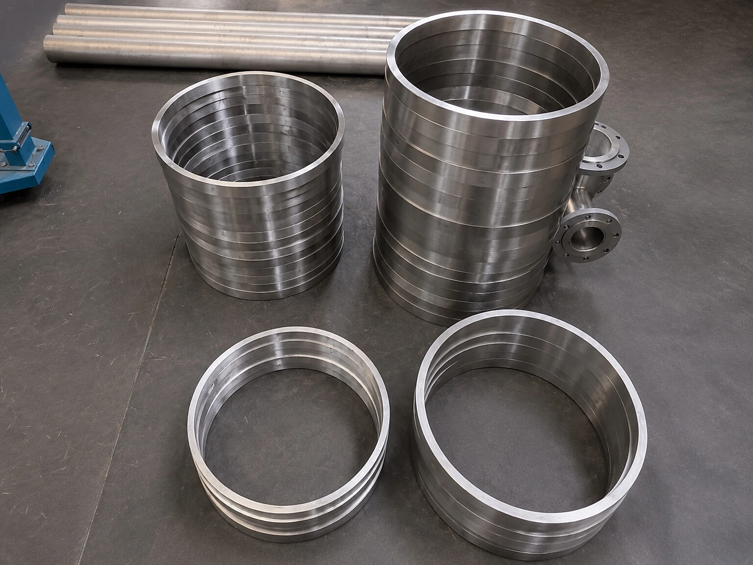 Batch of machined titanium-like rings and bar stock, showing why product-family evidence still has to be tied to part function and release authority.