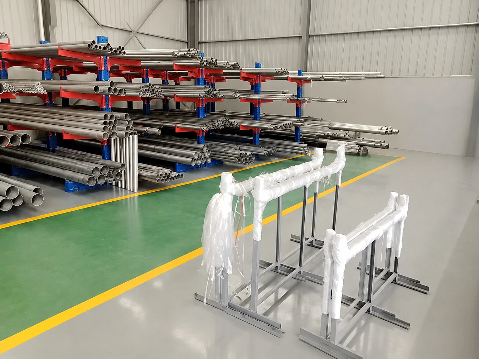 Clean titanium tube racks and wrapped product in warehouse storage, illustrating the product-form boundary between available stock and released buyer supply