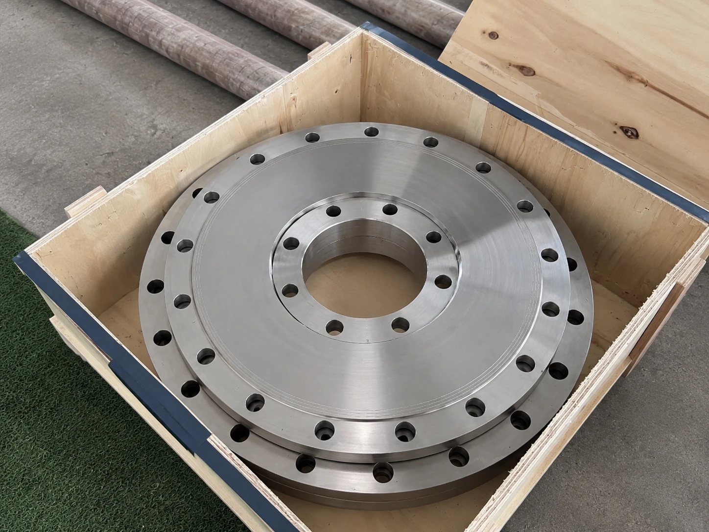 Machined titanium flange rings packed in a crate, showing that release evidence must travel with the finished geometry.