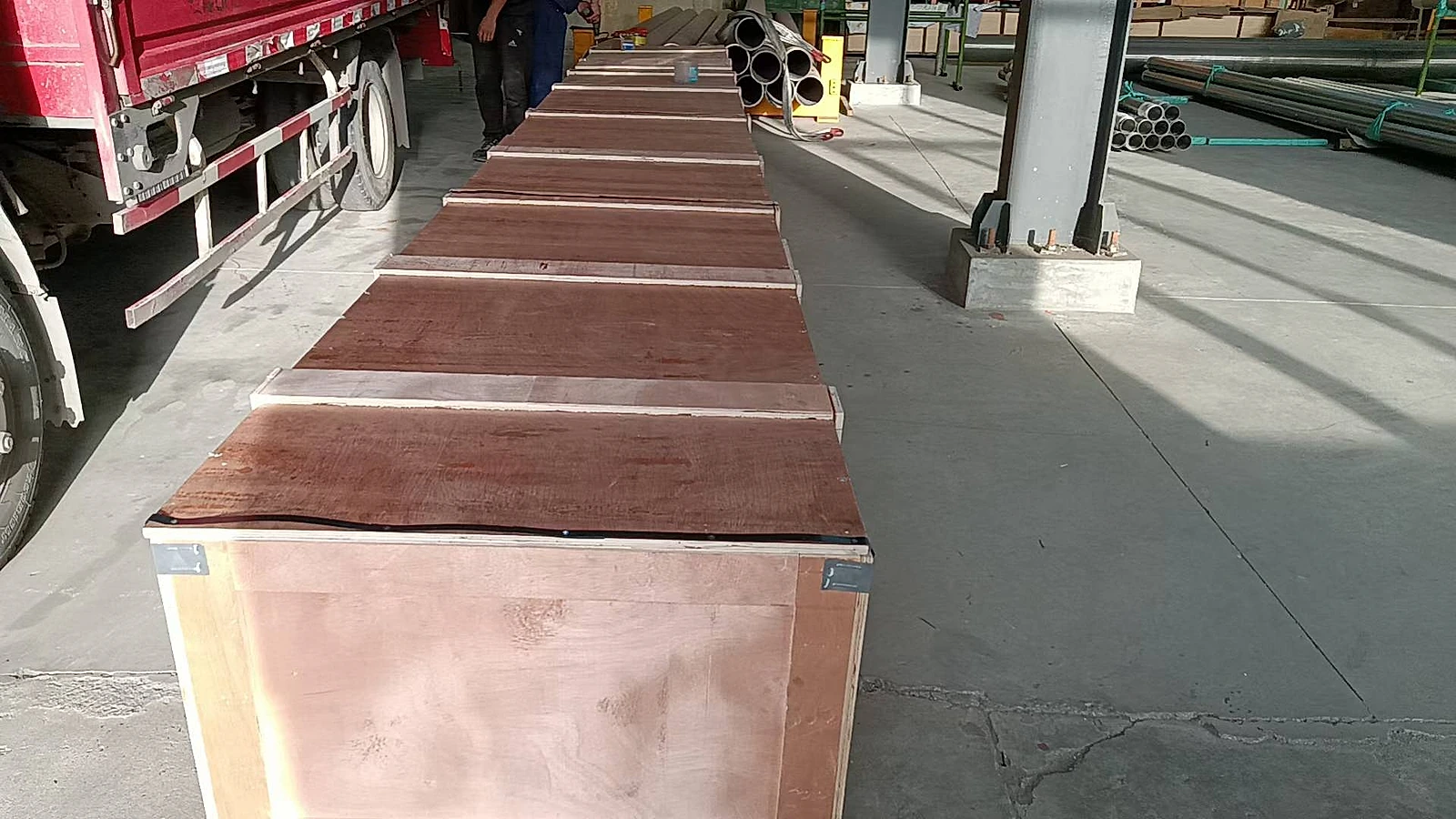 Heavy-wall Grade 5 titanium billet stacked in warehouse, showing multiple pieces with visible wall thickness